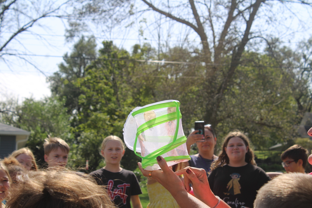 Student holding butterfly