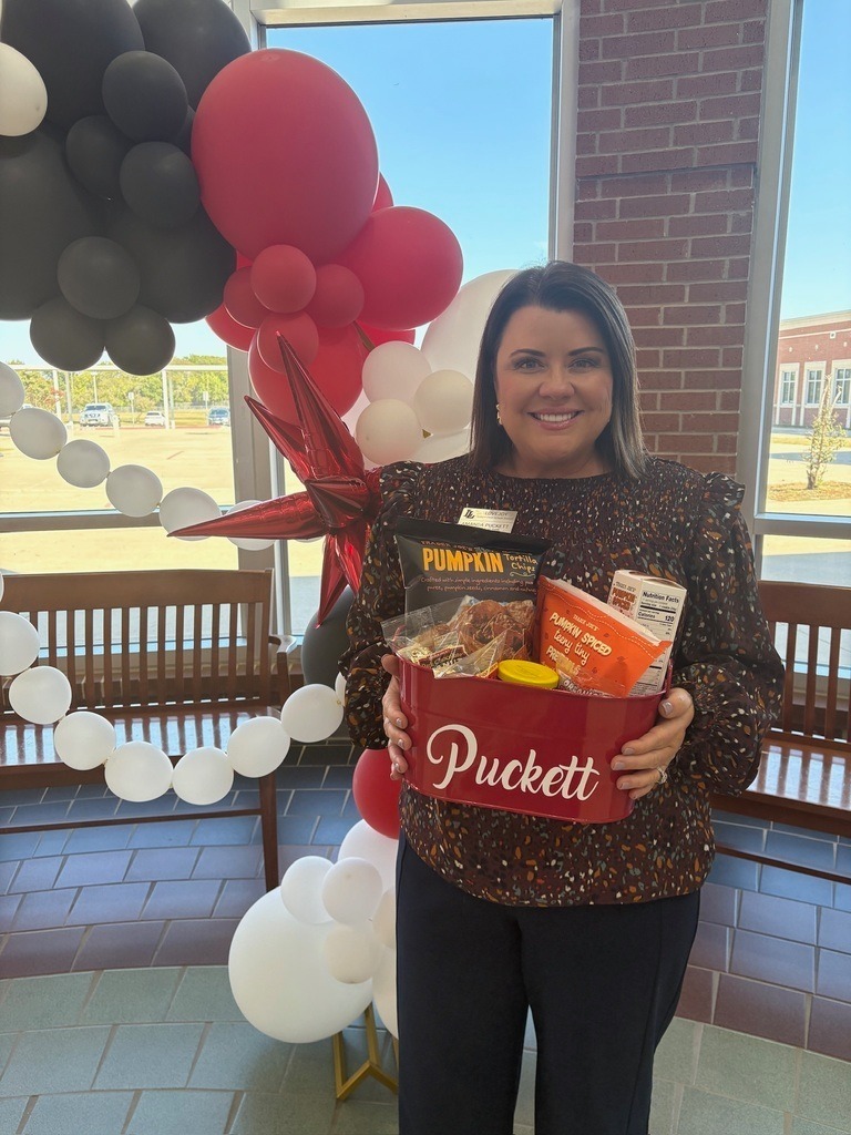 Principal Puckett holding a gift basket