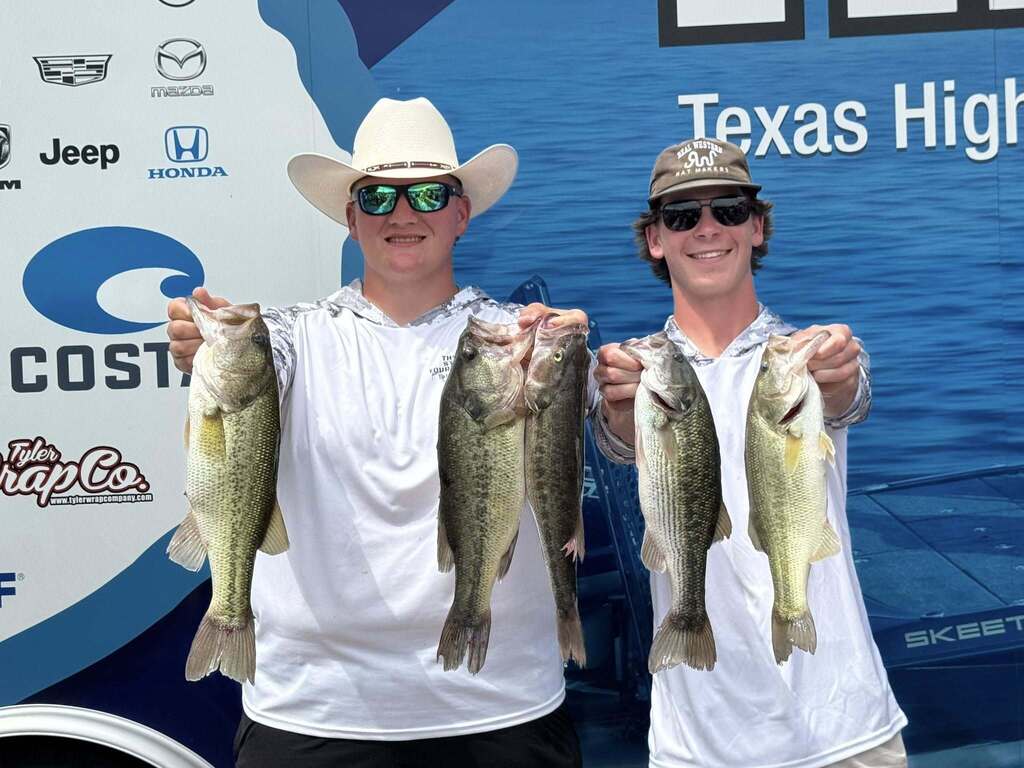 Two men in white cowboy hats, sunglasses, and white shirts display a collection of fish against a blue background with white letters.
