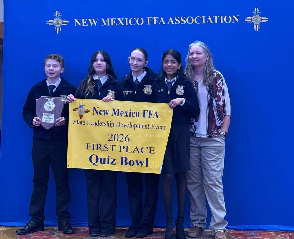 students pose with 1st place quiz bowl banner