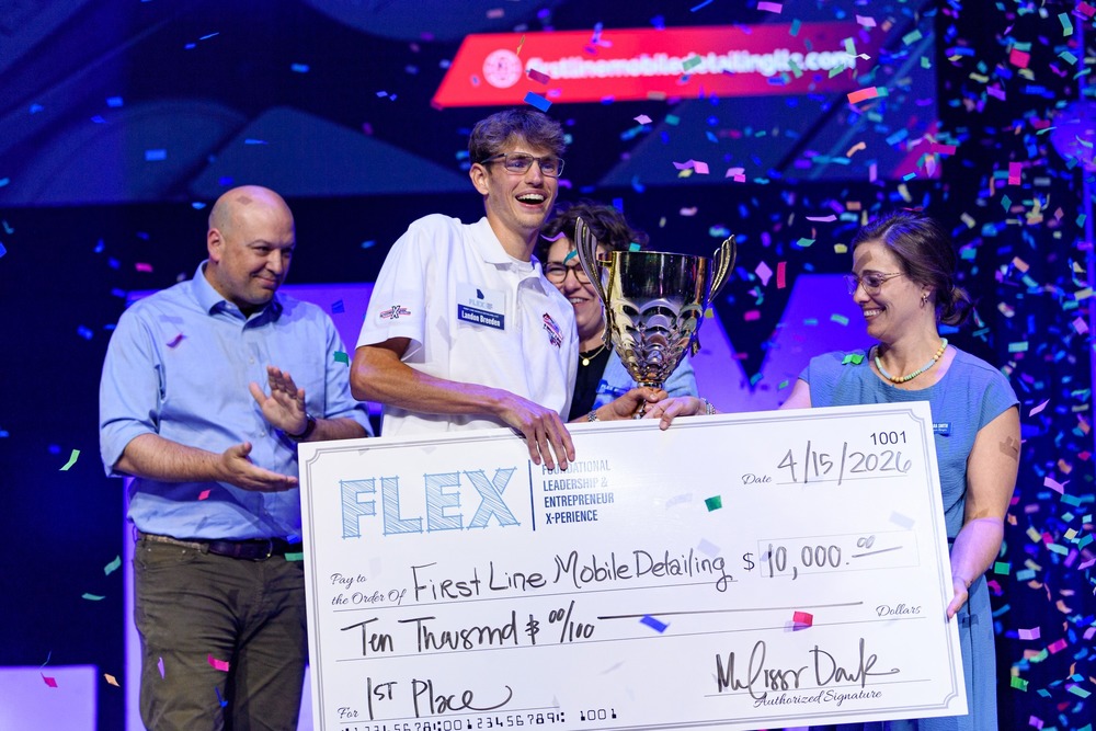 Landon receiving his trophy and check for winning