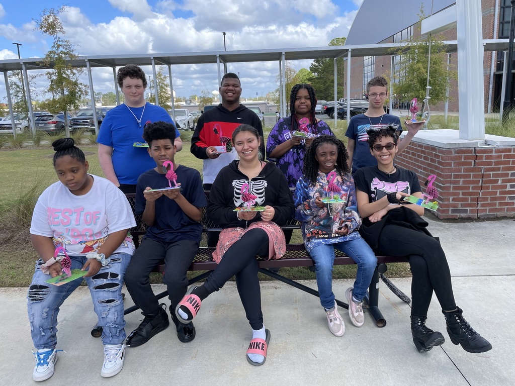 Students with their artwork