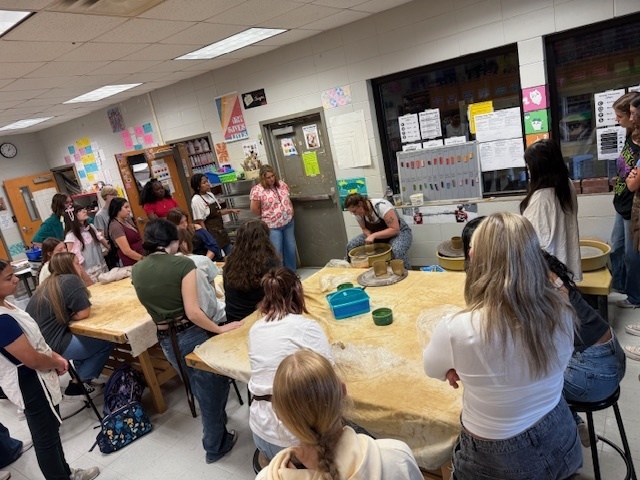 Local artist demonstrating the use of the potter' s wheel. 