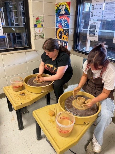 Students using the potter's wheel 