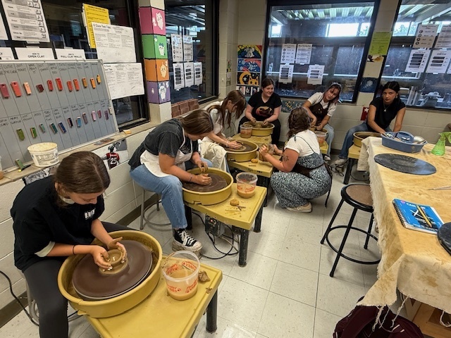 Students using the potter's wheel