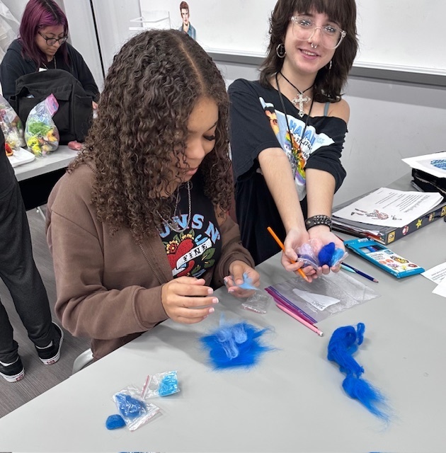 Students making felt from wool fibers