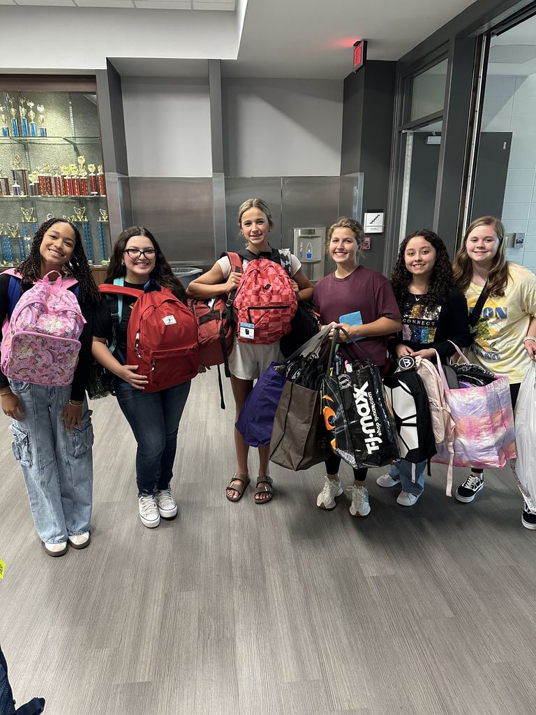 Students with loaded backpacks ready for delivery