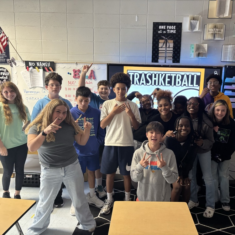 students posing in front of classroom