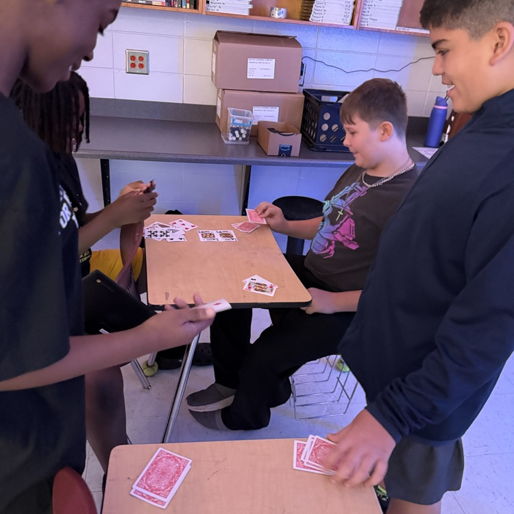 students playing card game to review math skills