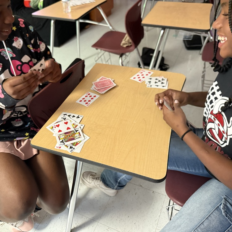 students playing card game to review math skills