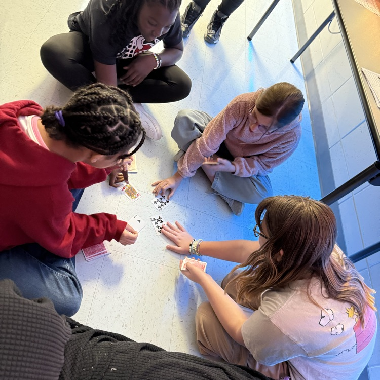 students playing card game to review math skills