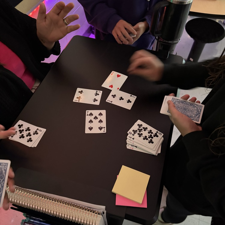 students playing card game to review math skills