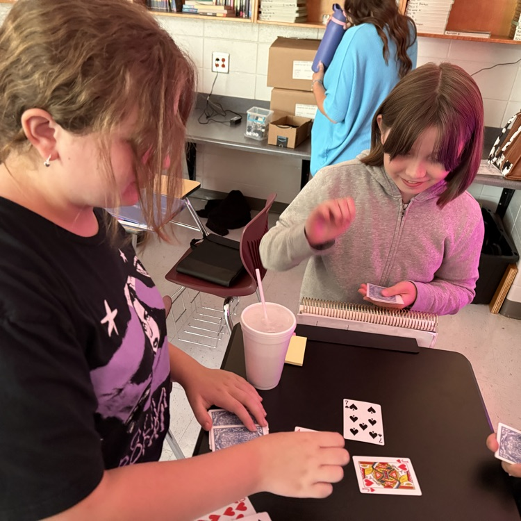 students playing card game to review math skills