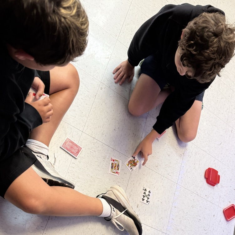 students playing card game to review math skills