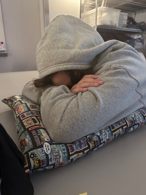 Student trying out pillow they made