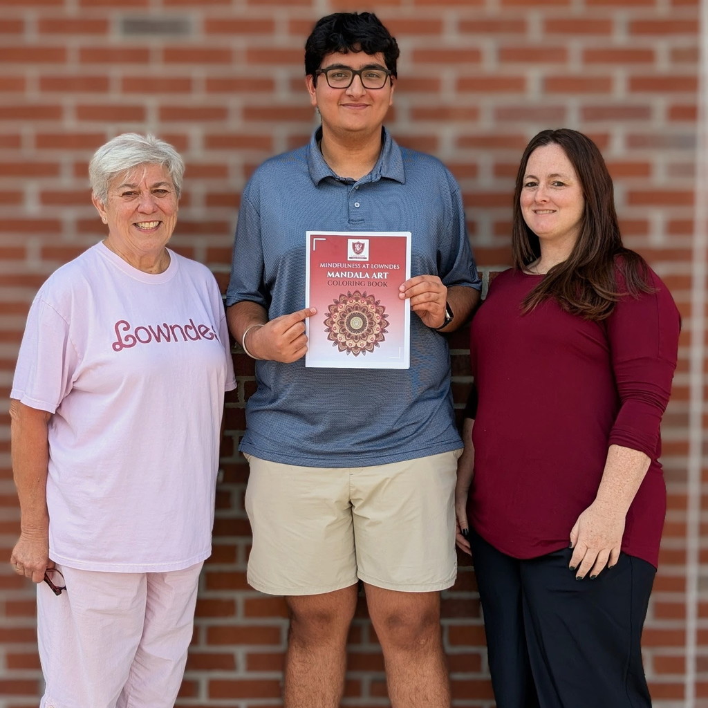 Vin with graphic arts teachers and his coloring book
