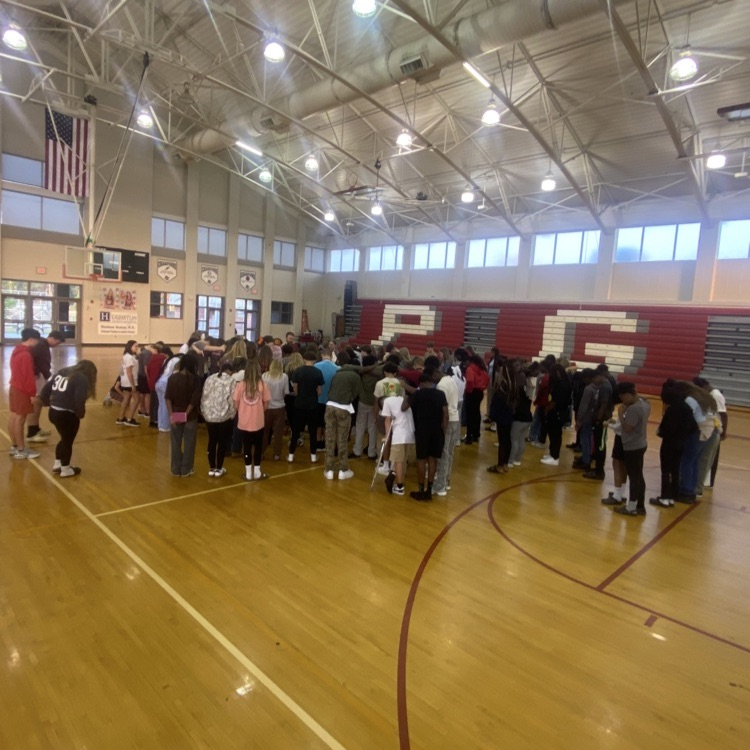 students praying in the gym