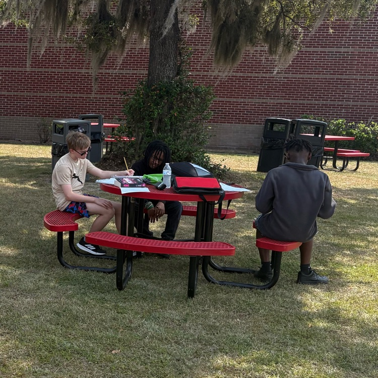 students working at picnic tables 