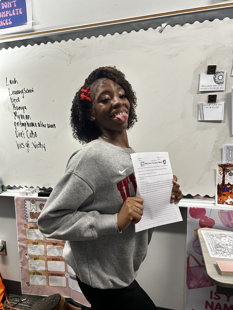 Student with their expository writing piece.
