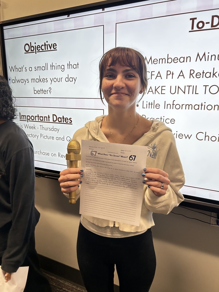Student with their expository writing piece.