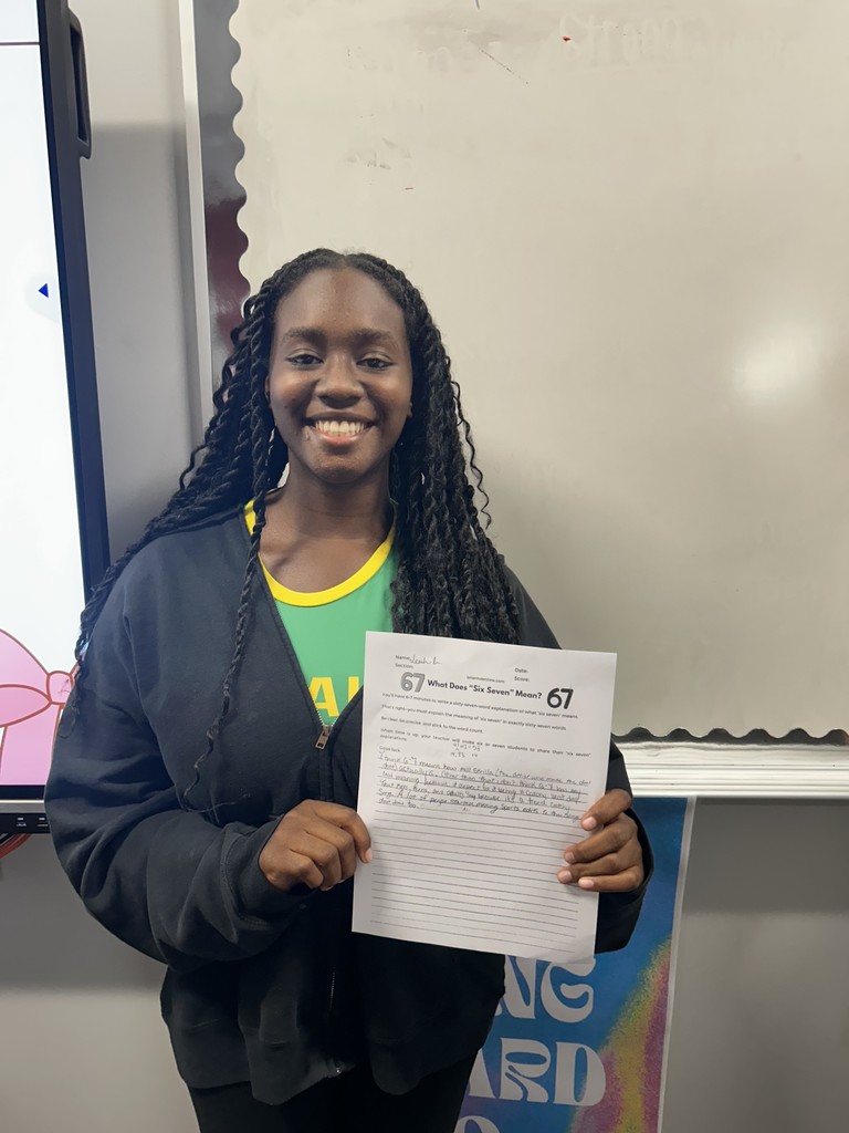 Student with their expository writing piece.