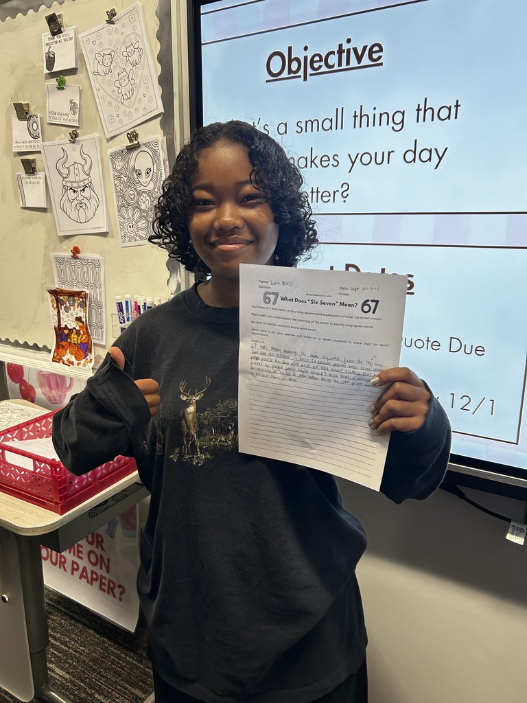 Student with their expository writing piece.