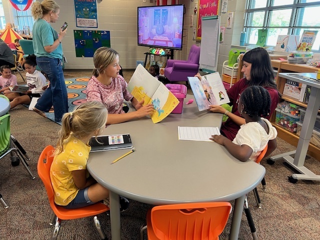 LHS Lit 1 students reading to WES 1st grade students