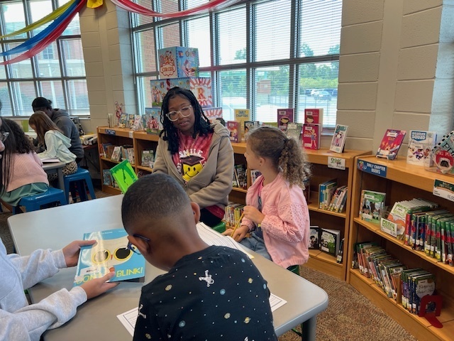 LHS Lit 1 students reading to WES 1st grade students
