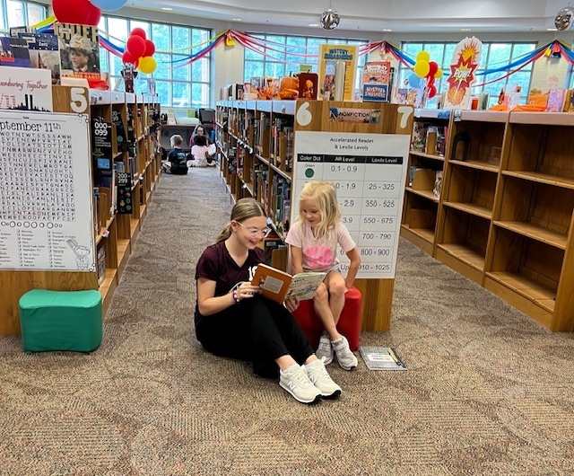LHS Lit 1 students reading to WES 1st grade students