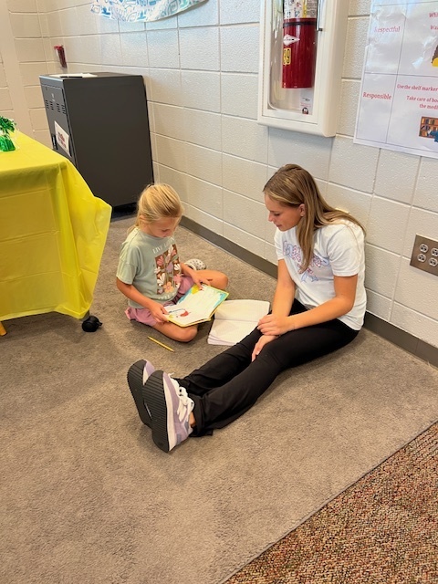 LHS Lit 1 students reading to WES 1st grade students
