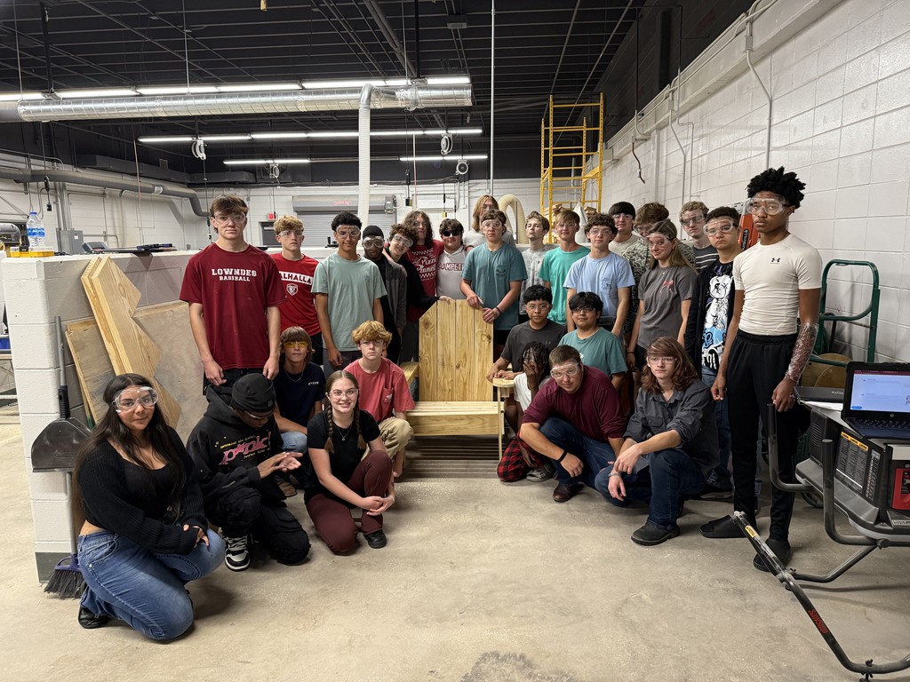 Construction students with the adirondak chair they constructed.
