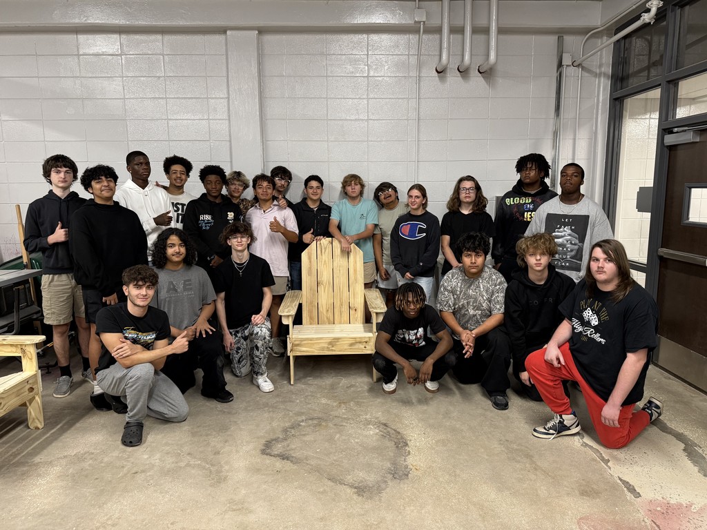 Construction students with the adirondak chair they constructed.