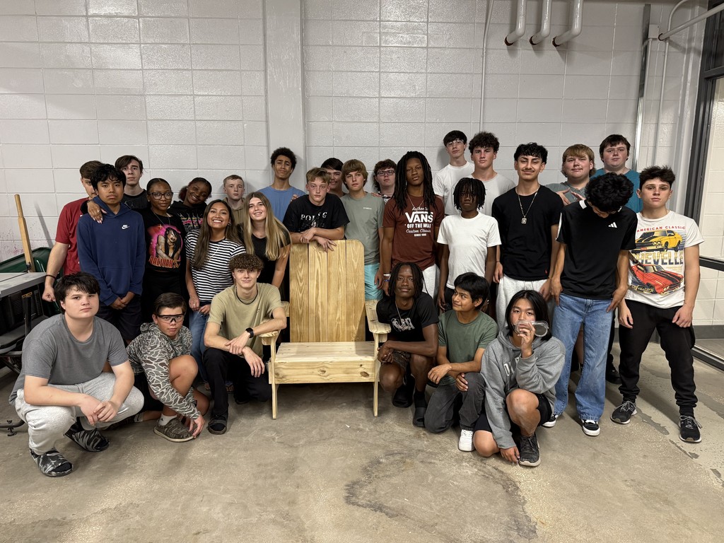 Construction students with the adirondak chair they constructed.
