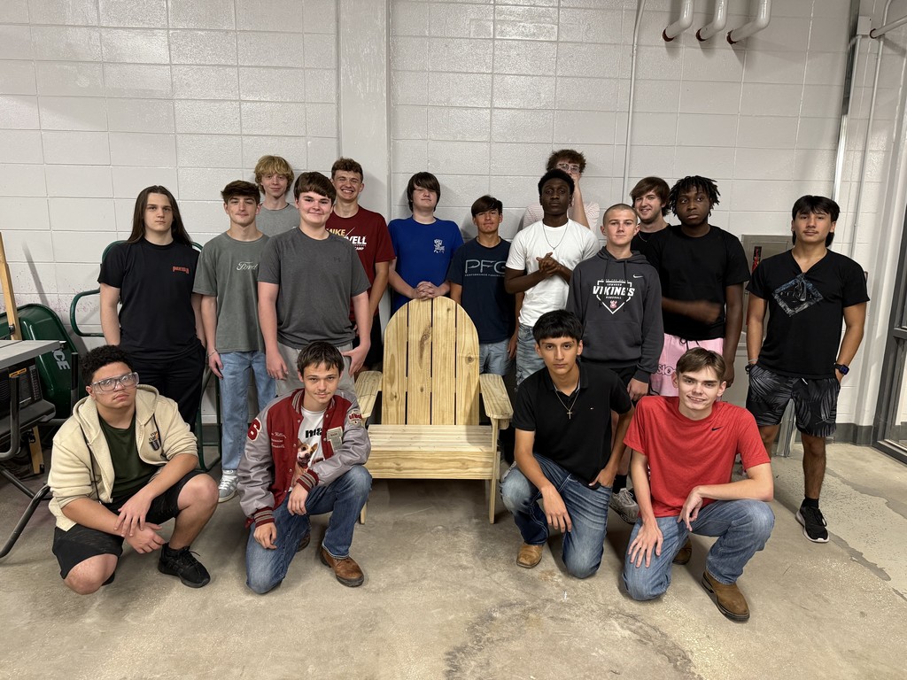 Construction students with the adirondak chair they constructed.