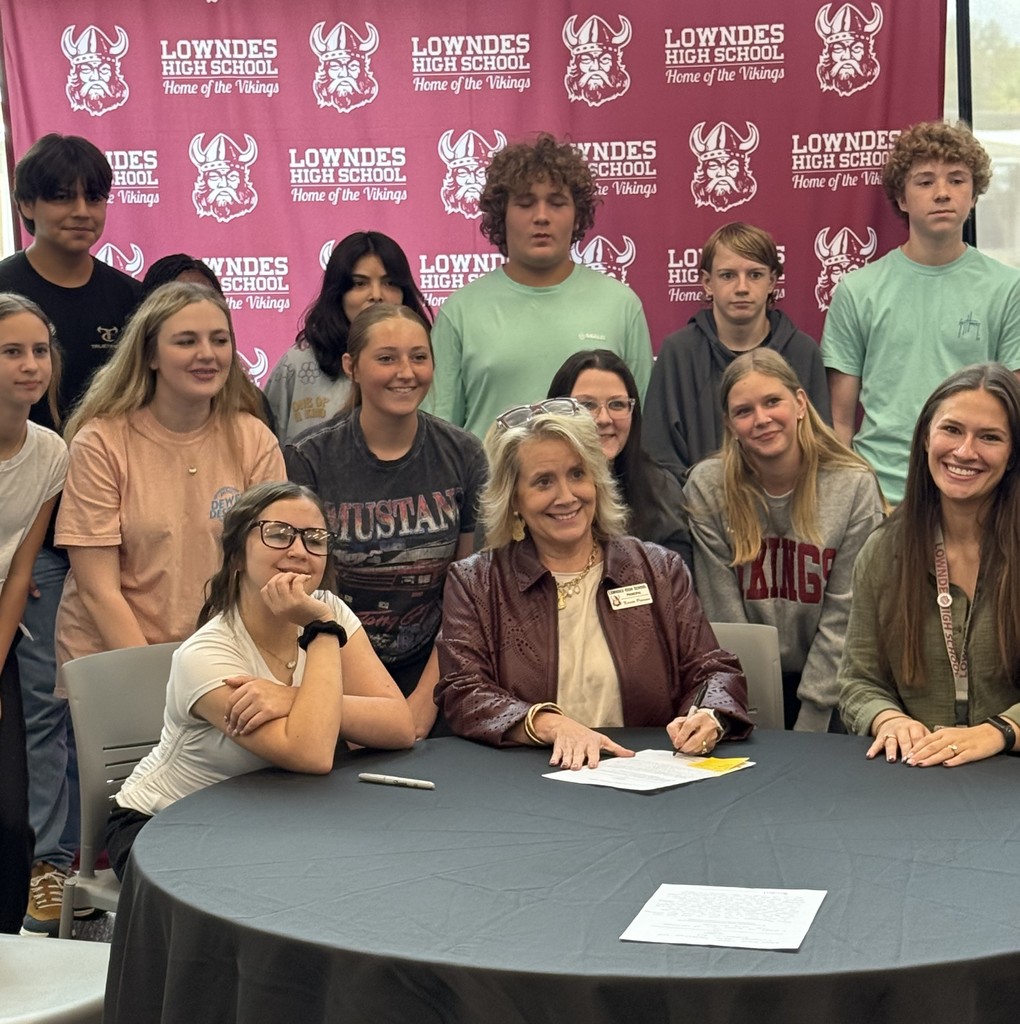 Mrs. Pearson signing a proposed bill for Mrs. McDonald's class