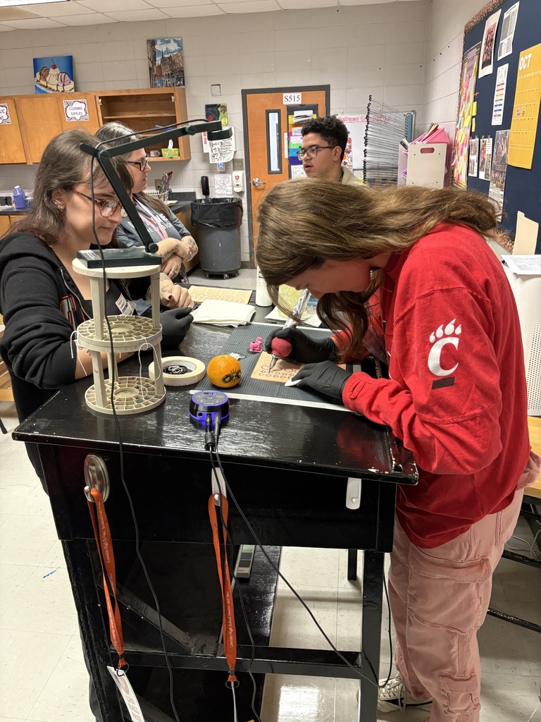 Student practicing on fake skin with supervision