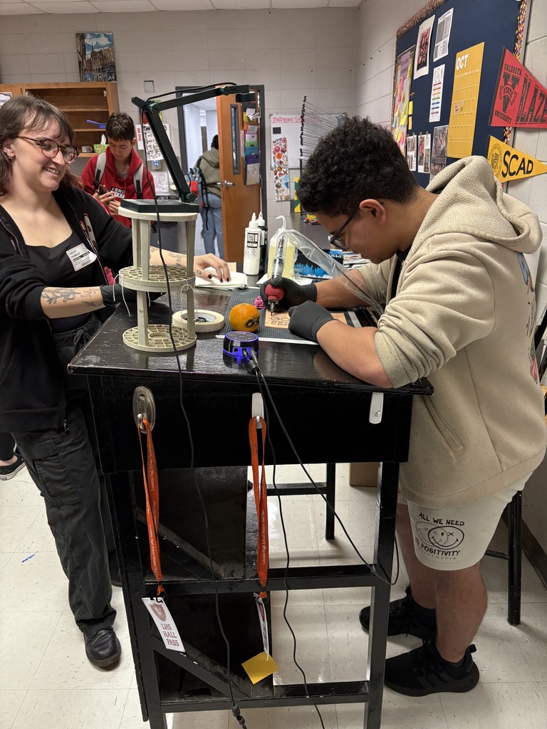 Student practicing on fake skin with supervision