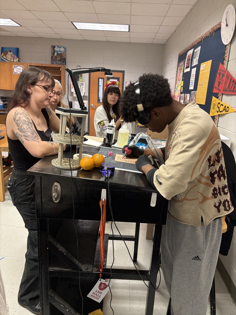 Student practicing on fake skin with supervision