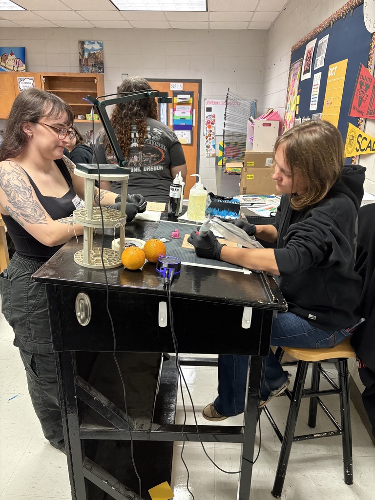 Student practicing on fake skin with supervision