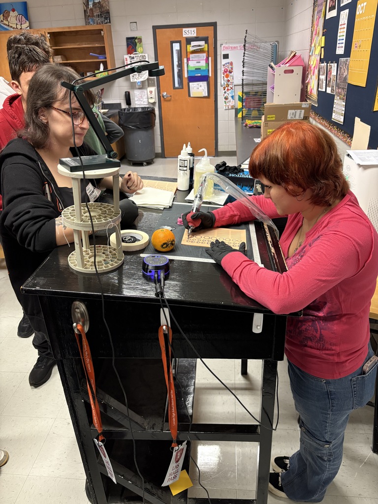 Student practicing on fake skin with supervision