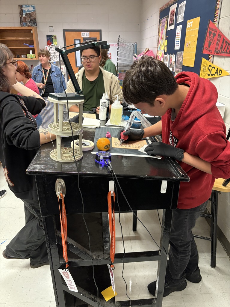 Student practicing on fake skin with supervision
