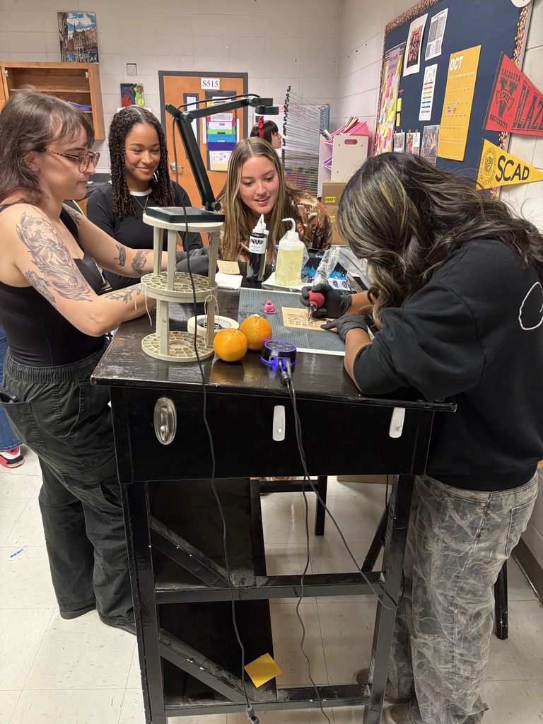 Student practicing on fake skin with supervision