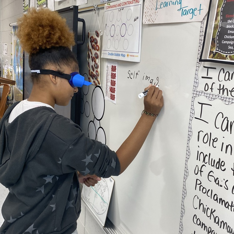student doing activity wearing upside down goggles 