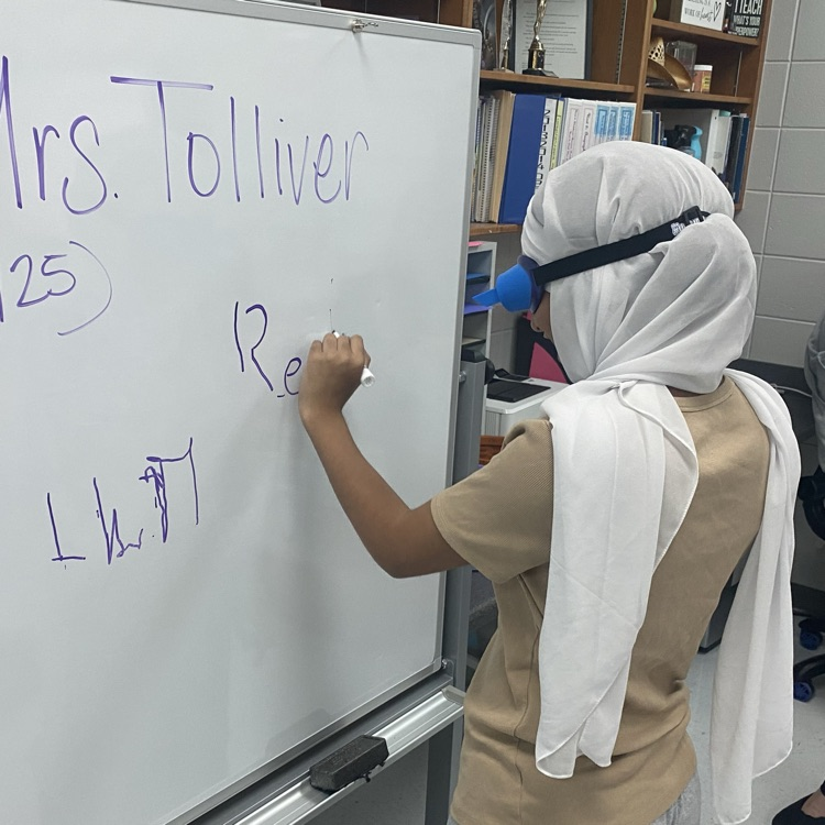 student doing activity wearing upside down goggles 