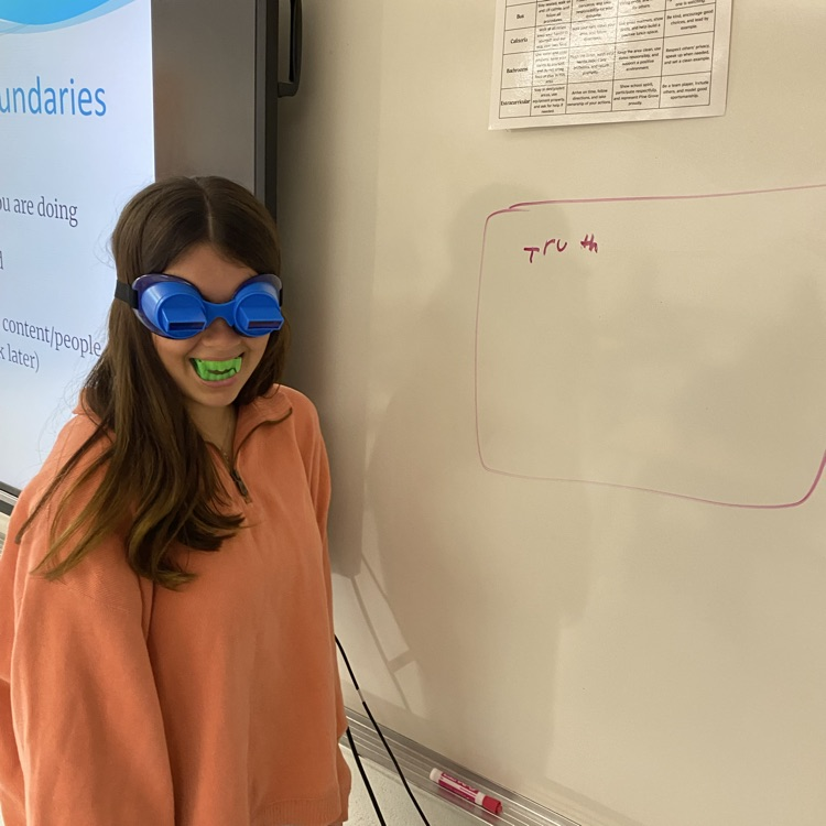 student doing activity wearing upside down goggles 