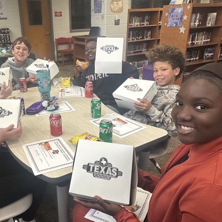 students posing with lunch 