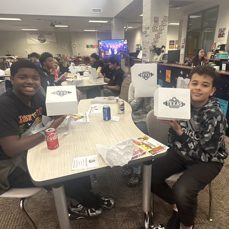 students posing with lunch 