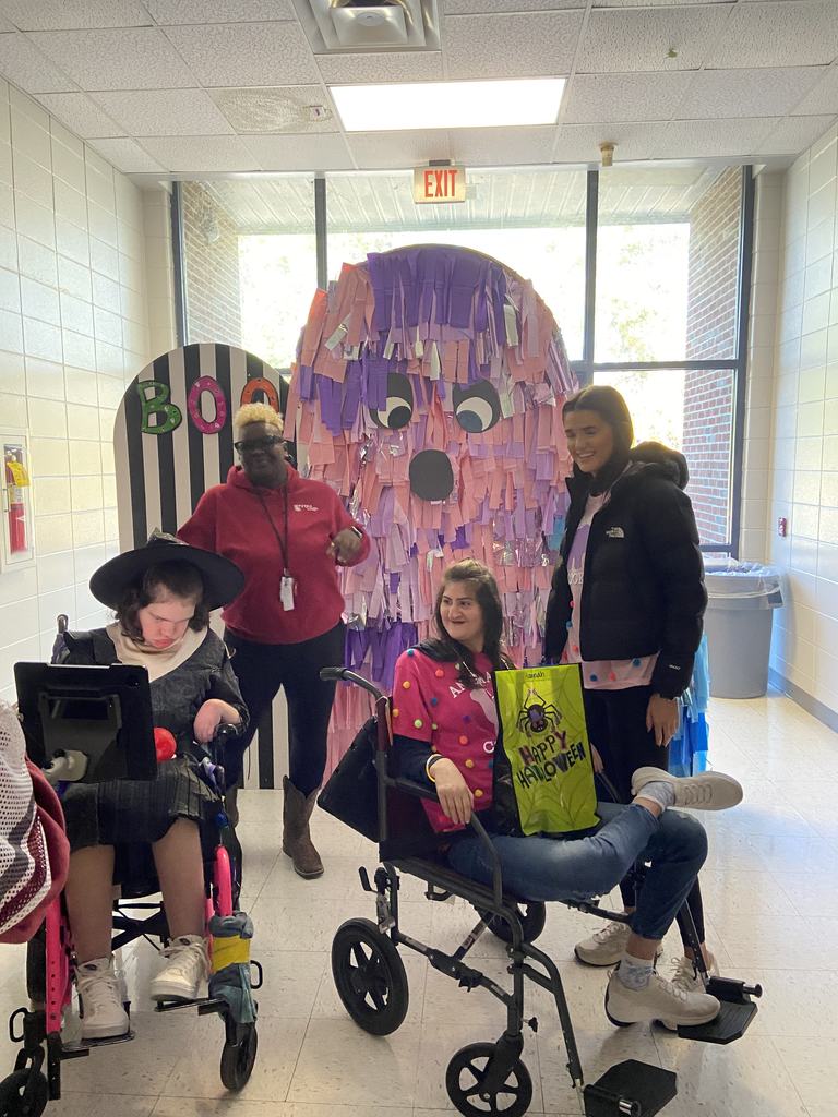 Students in front of a halloween decoration