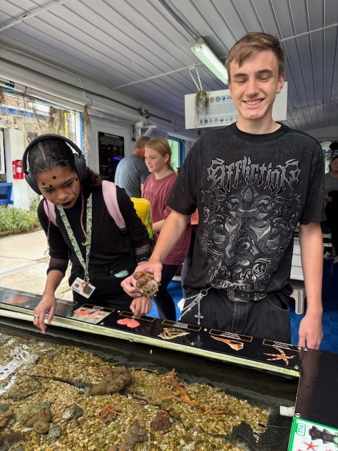 Student holding a sea specimen
