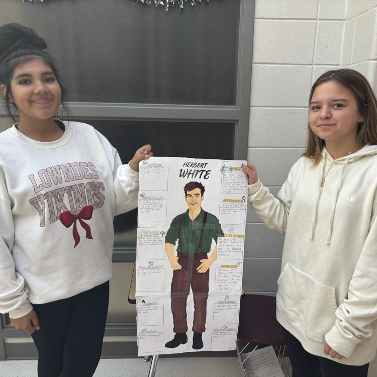 students holding work 